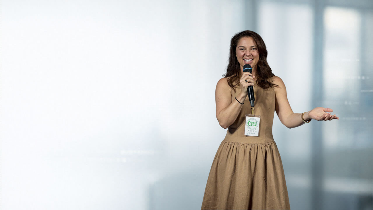Jen Seregos speaking on stage